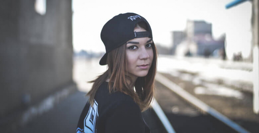 Woman in Black Shirt and Black Snap Back Cap